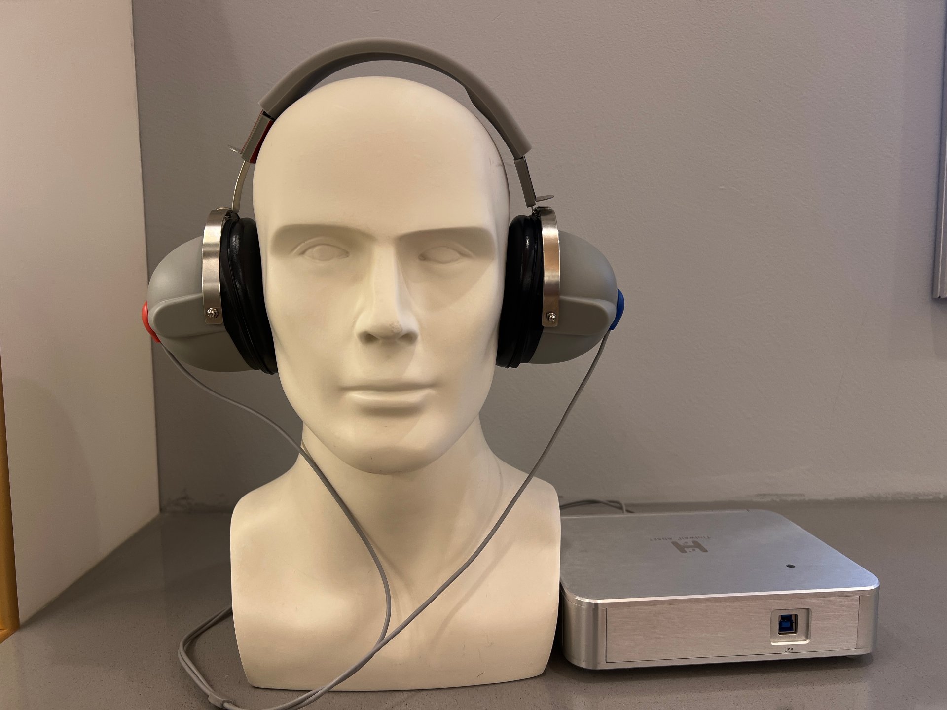 An audiometer with a pair of headphones attached, set up for a hearing assessment